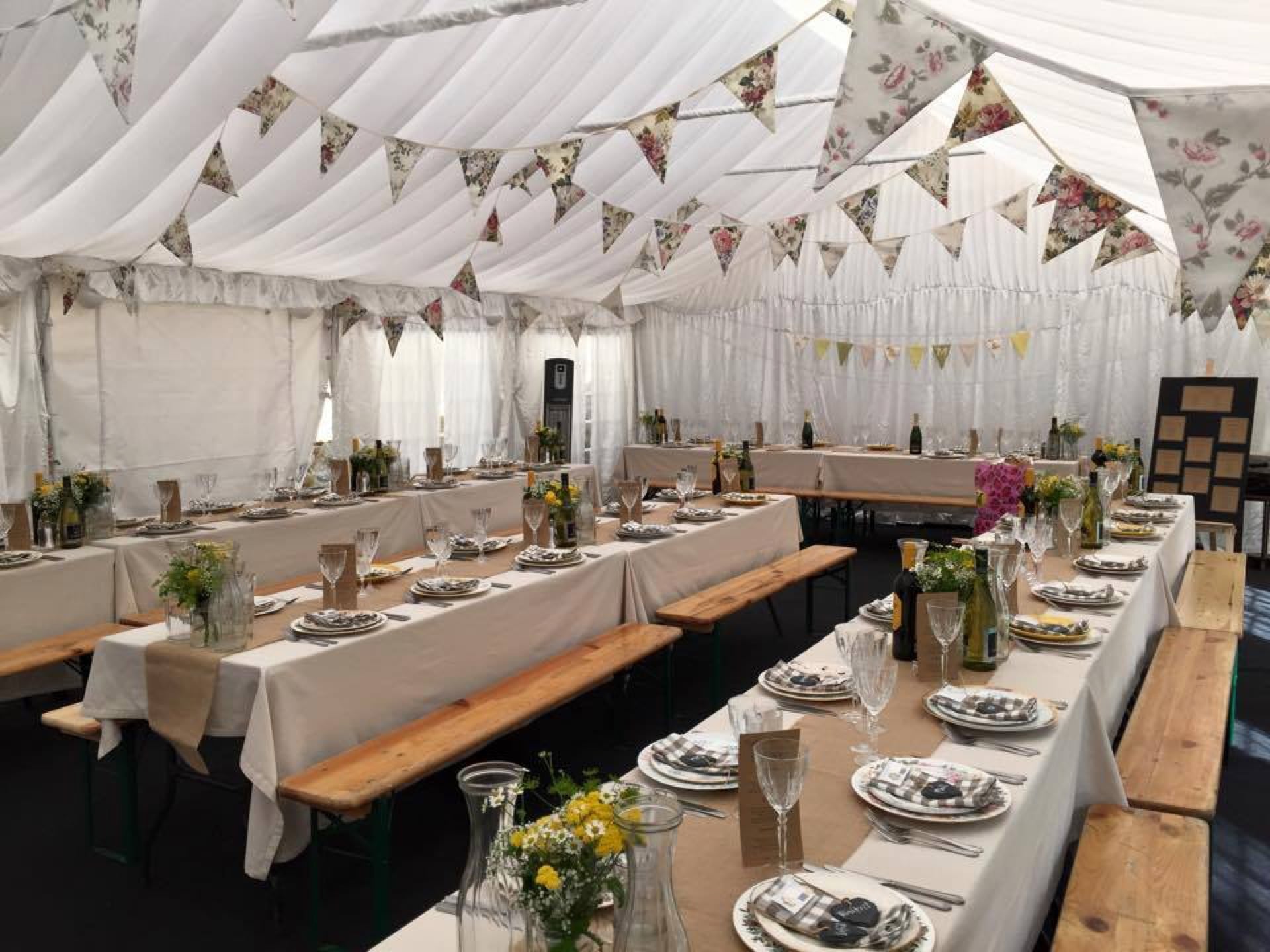 rows of tables dressed in marquee